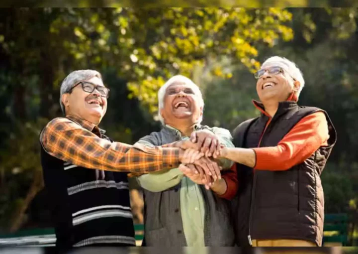 Elderly Indian couple sharing life experiences and smiling in a peaceful senior care home environment.